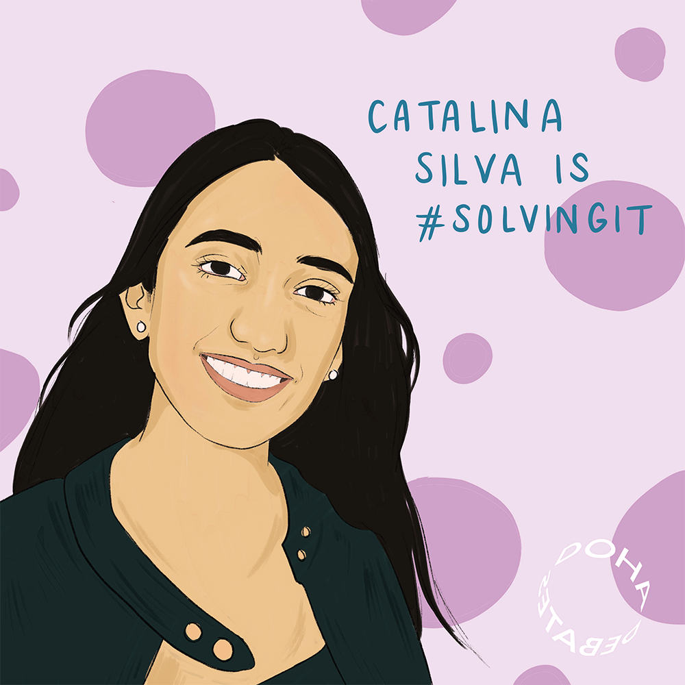 Illustration of a smiling woman with long black hair. She is wearing a black jacket and small round white earrings. She is standing against a lilac background with purple dots, and text over the illustration reads, “Catalina Silva is #SolvingIt.”
